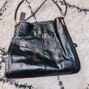 Coach purse with black and white side detailing.